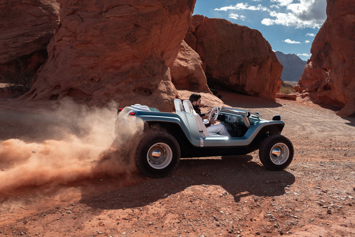 Meyers Manx Resorter NEV driving through a red rock canyon