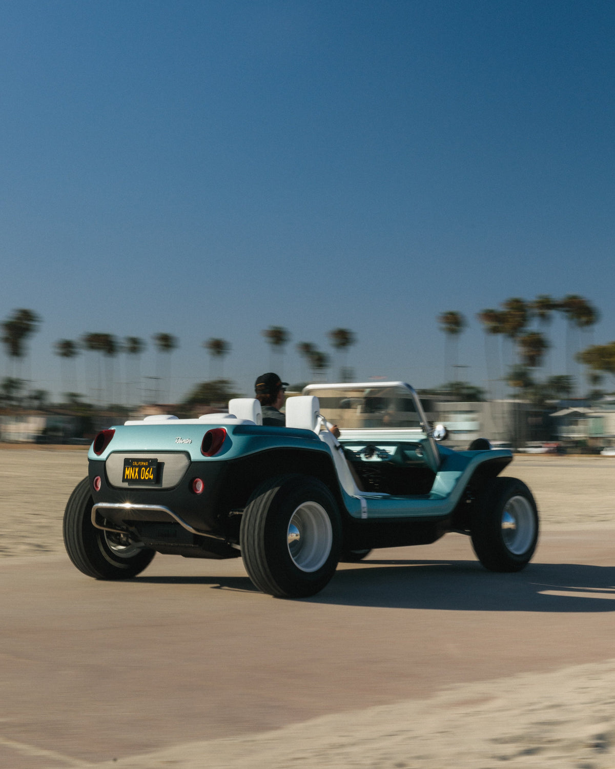 Meyers Manx Resorter NEV on a beach road lined with palms